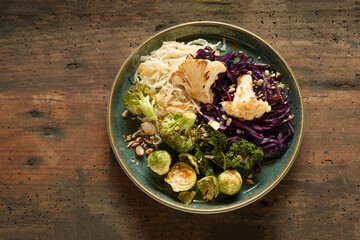 Grilled cabbages and noodles on plate