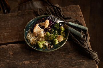 Plate with vegetarian dish and forks on table