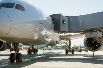Boarding passengers on the plane through the boarding bridge. The plane lands at the international...