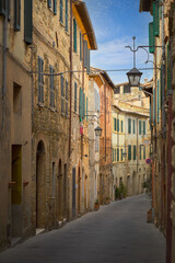 Narrow street with medieval houses, Montalcino, Italy