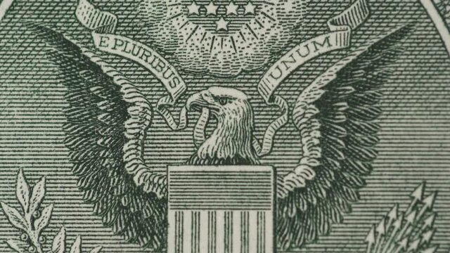 Zooming in effect to eagle with flag on dollar bill. Power, finance and strength concept