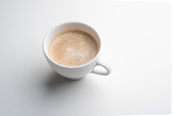 White cup of coffee in soft light isolated on a white background. Cappuccino coffee. 