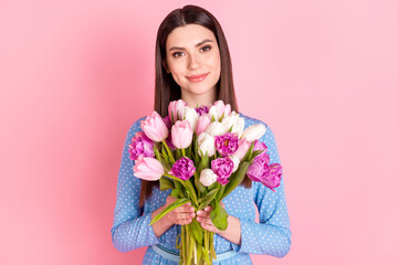 Photo of young beautiful attractive charming positive girl hold bouquet flowers isolated on pink color background