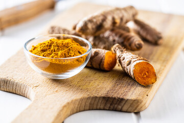 Indian turmeric powder and root. Turmeric spice. Ground turmeric
