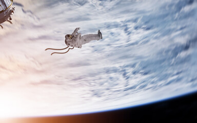 Astronaut in a cut of from space station in space orbit.