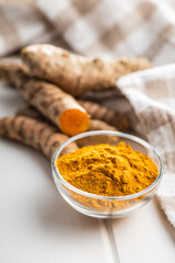 Indian turmeric powder and root. Turmeric spice. Ground turmeric