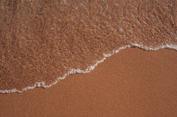 Ocean wave or clear sea on clean sandy beach summer concept. Brown color filter.