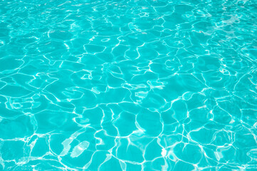 Surface of blue swimming pool. Summer background. Texture of water surface