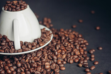 coffee grain on inverted mug and saucer on gray Arabica table