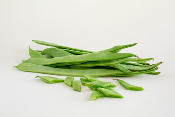 Green runner beans whole and sliced on white background isolated
