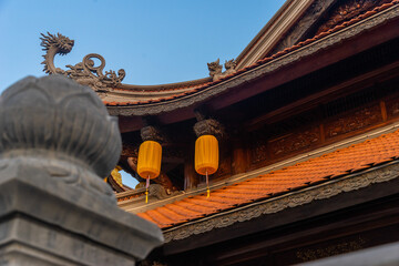 Fototapeta na wymiar Beautiful traditional yellow silk lanterns are are hanging on the roof of the temple at Vinh Nghiem monastery in Ho Chi Minh city, Vietnam