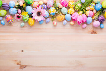 Happy Easter day colorful eggs and flower decoration on wood background with copy space
