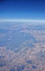 Clouds and sky as seen through window of an aircraft