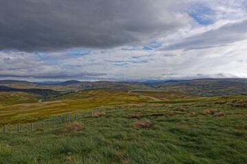 The Hills of Cromdale within the Cairngorm National Park seen from a small minor road that passes through the landscape.