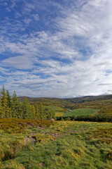 A Small White Scottish Castle seen in the distance in the Hills of Cromdale on the small road out of the Highland Village of Tomintoul.