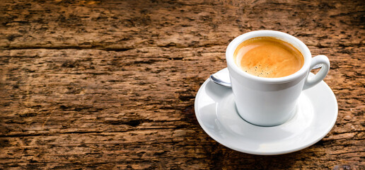 top view on cup of coffee over grunge wooden bacgkround