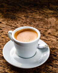 top view on cup of coffee over grunge wooden bacgkround