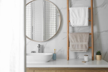 Decorative ladder near vessel sink in stylish bathroom. Idea for interior design