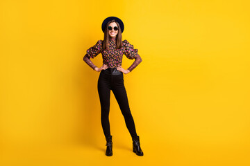 Fototapeta na wymiar Full length body size photo of girl wearing stylish outfit sunglass black hat smiling isolated on vibrant yellow color background