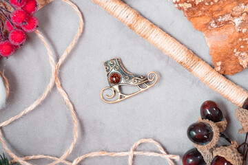 Bronze and amber pendant in the form of a skate