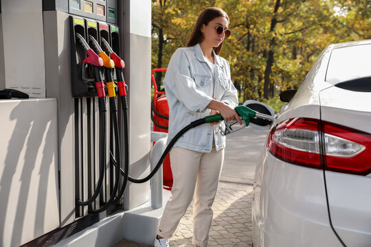 Woman Refueling Car At Self Service Gas Station