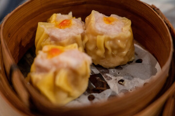 Siu Mai dumplings in bamboo steamer in yum cha Chinese restaurant

