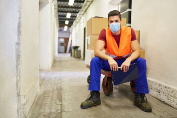 Workers with face masks because of Covid-19 in the warehouse