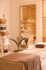 Stylish massage room interior in spa salon