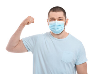 Man with protective mask showing muscles on white background. Strong immunity concept