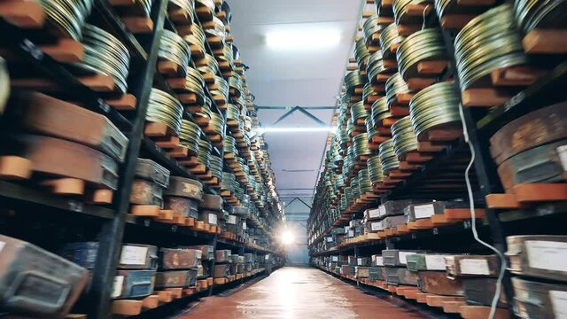 Rows of shelves with packaged film tapes on them. Vintage movie, old cinema concept.