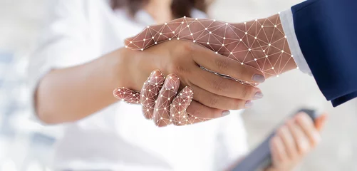 Foto op Plexiglas close up on businesswoman hand shaking with robotic AI hologram to confirm and dealing for business and technology innovation of RPA concept © chinnarach