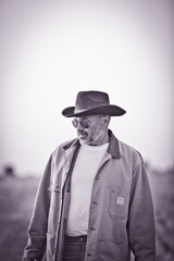 Farmer on the field wearing hat and work clothes