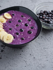 Smoothie porridge for breakfast with banana and blueberries in a bowl