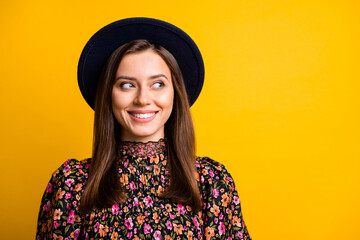 Portrait of cute optimistic girl look empty space wear black cap shirt isolated on vibrant yellow color background