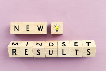 concept image with new mindset new results text over wooden cubes