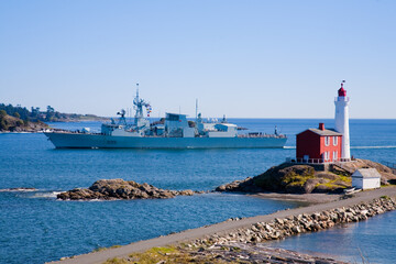 Fisgard Lighthouse with navy destroyer sailing past, Victoria, BC