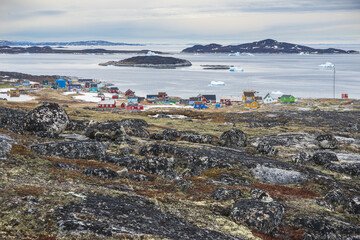 Aerial shot of colorful houses at Ilimanaq on the Disko Bay background