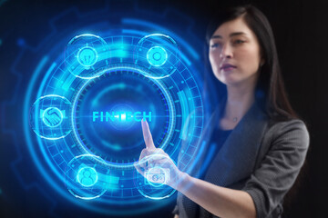 Business, Technology, Internet and network concept. Young businessman working on a virtual screen of the future and sees the inscription: Fintech
