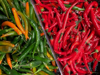 Red and green hot chilli peppers pattern texture background.