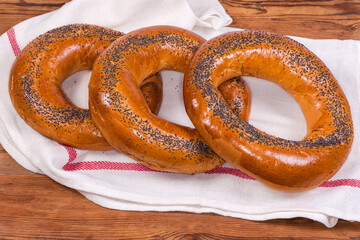 Poppy seed ring-shaped bread rolls on a napkin