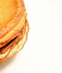 A stack of pancakes on a white background. Selective focus.