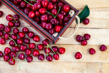 Ripe cherries in a wooden box.
