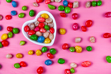 Multicolored candies in a plate in the shape of a heart