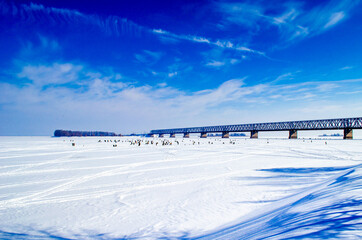 Fishermans fishing in the winter under the bridge