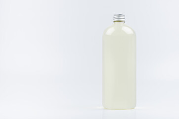 Plastic tall bottle with pale drink, silver cap mockup on white background. Template for portfolio, design, branding identity.
