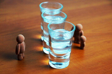 glasses with alcohol separate man from woman with child, family alcoholism concept