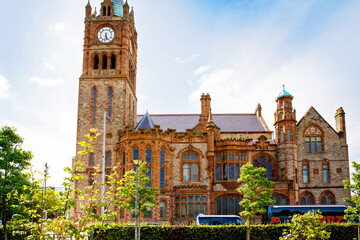 Fototapeta premium Derry, North Ireland. Aerial view of Derry Londonderry city center in Northern Ireland, UK. Sunny day with cloudy sky, city walls and historical buildings