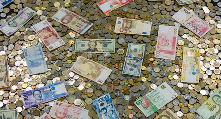 Coins and banknotes from different countries close up view.