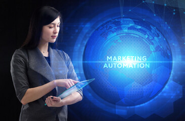 Business, Technology, Internet and network concept. Young businessman working on a virtual screen of the future and sees the inscription: Marketing automation