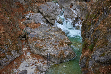 beautiful landscape with a mountain river with small waterfalls in winter day in the canyon.